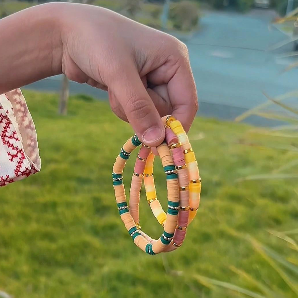 Set of three colourful boho chic Heishi bracelets with mixed vibrant beads, perfect for stacking